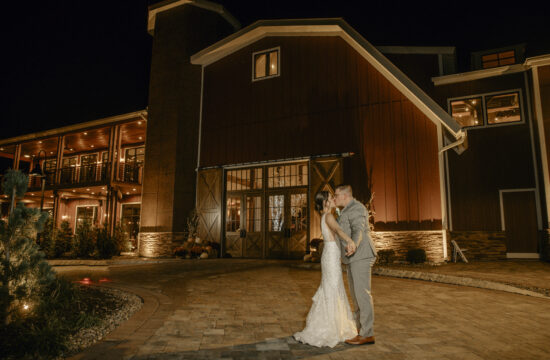 Bride and Groom Kiss for a Nighttime photo in front of Barn at a Hudson Valley Wedding at The Barn at Villa Venezia