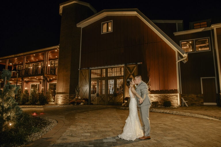 Bride and Groom Kiss for a Nighttime photo in front of Barn at a Hudson Valley Wedding at The Barn at Villa Venezia