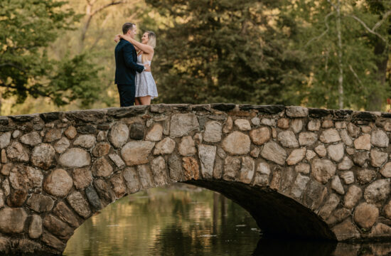 Bride and Groom Hug on a stone bridge during a Binney Park Engagement Shoot in Greenwich Connecticut
