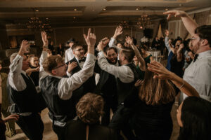 Groom dances with guests at a Hudson Valley Wedding at Villa Barone Hilltop Manor