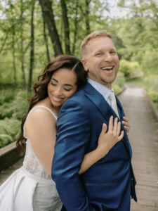 Bride Hugs Groom and Smiles for a photo at a Winding Hills Wedding in the Hudson Valley