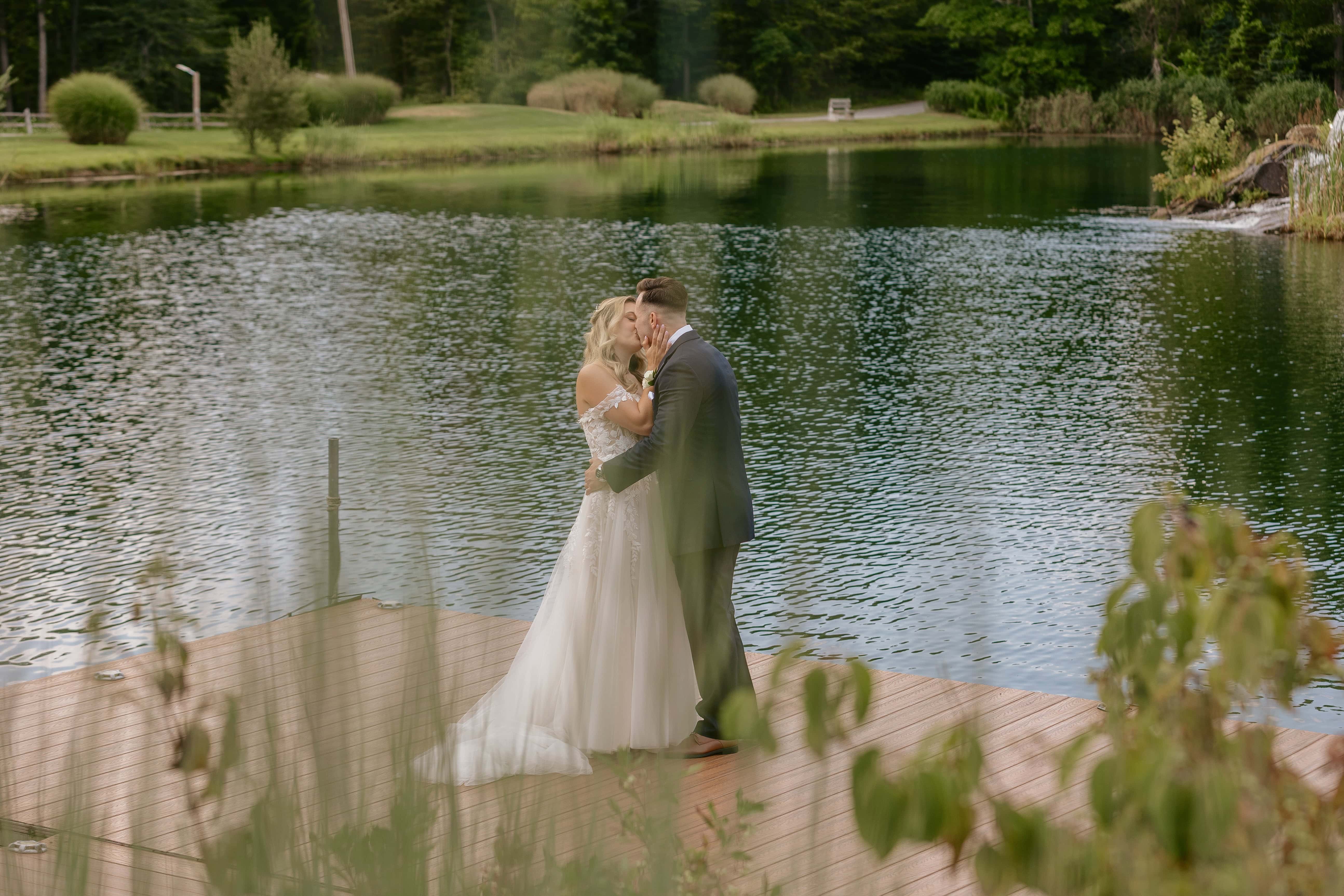 Bride and Groom Kiss and Hug on pier for a New Jersey Wedding Photo at Rock island Lake Club