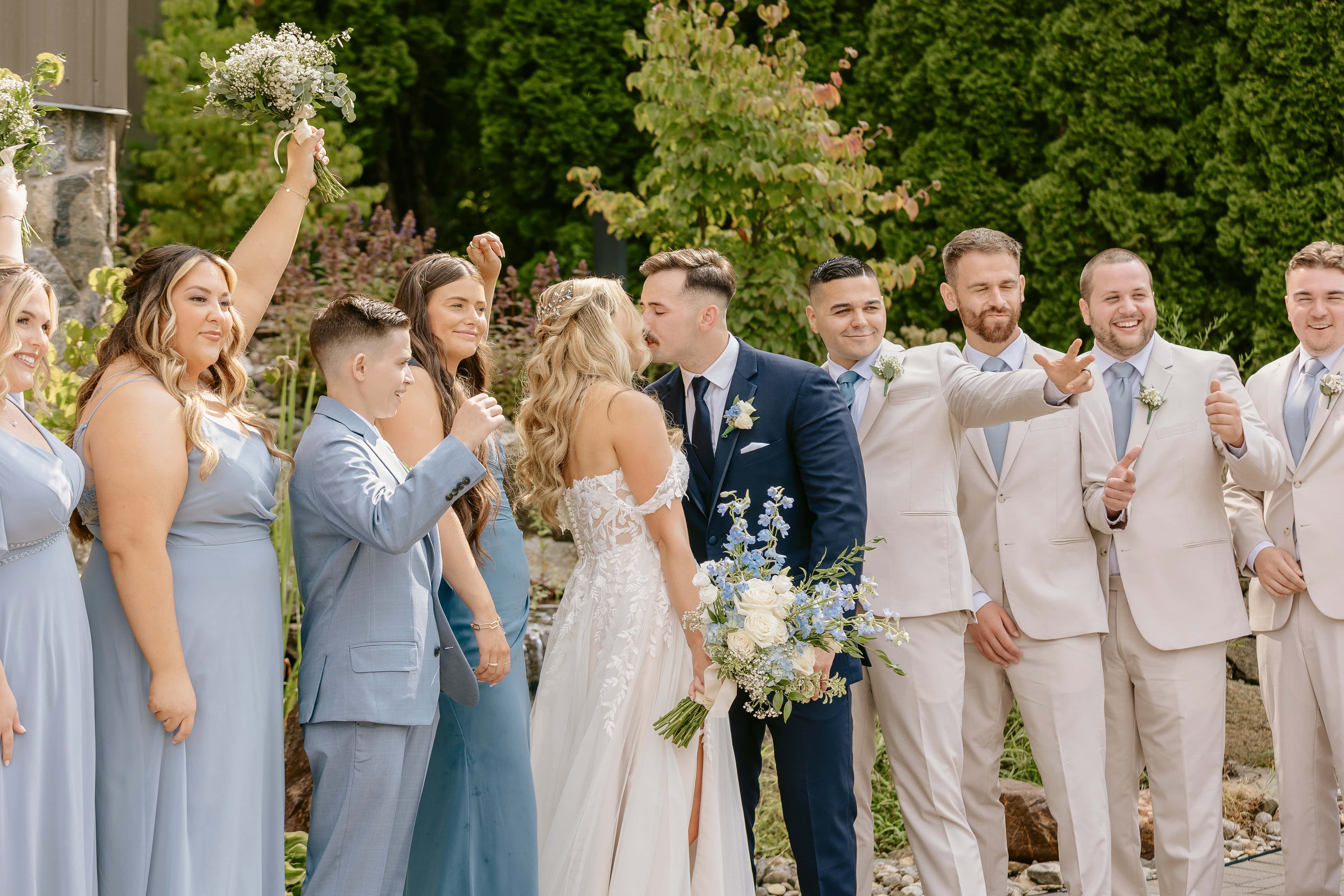 bride and Groom Kiss surrounded by wedding party for a New Jersey Wedding Photo at Rock island Lake Club