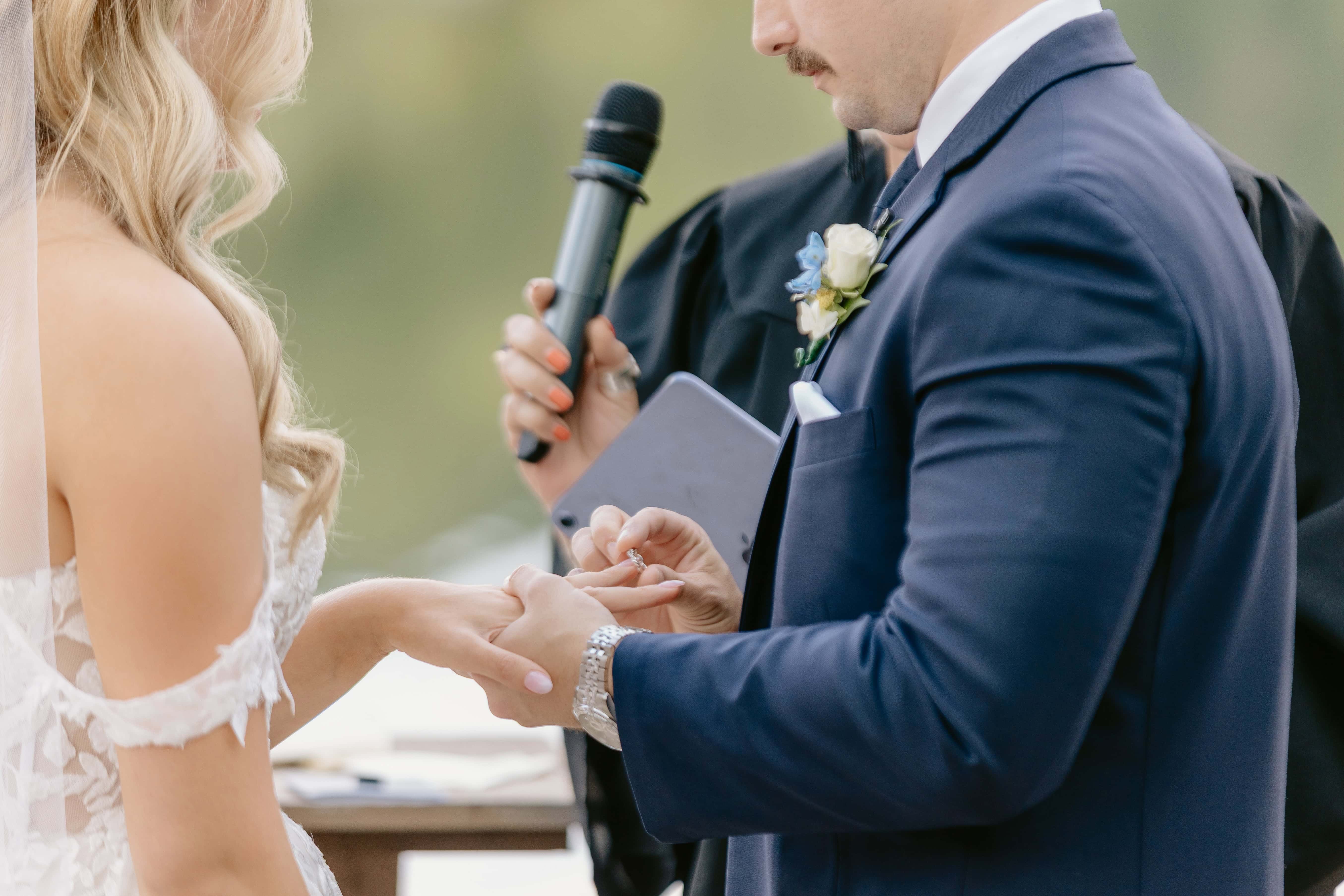 Groom puts Ring on bride during Ceremony for a New Jersey Wedding Photo at Rock island Lake Club