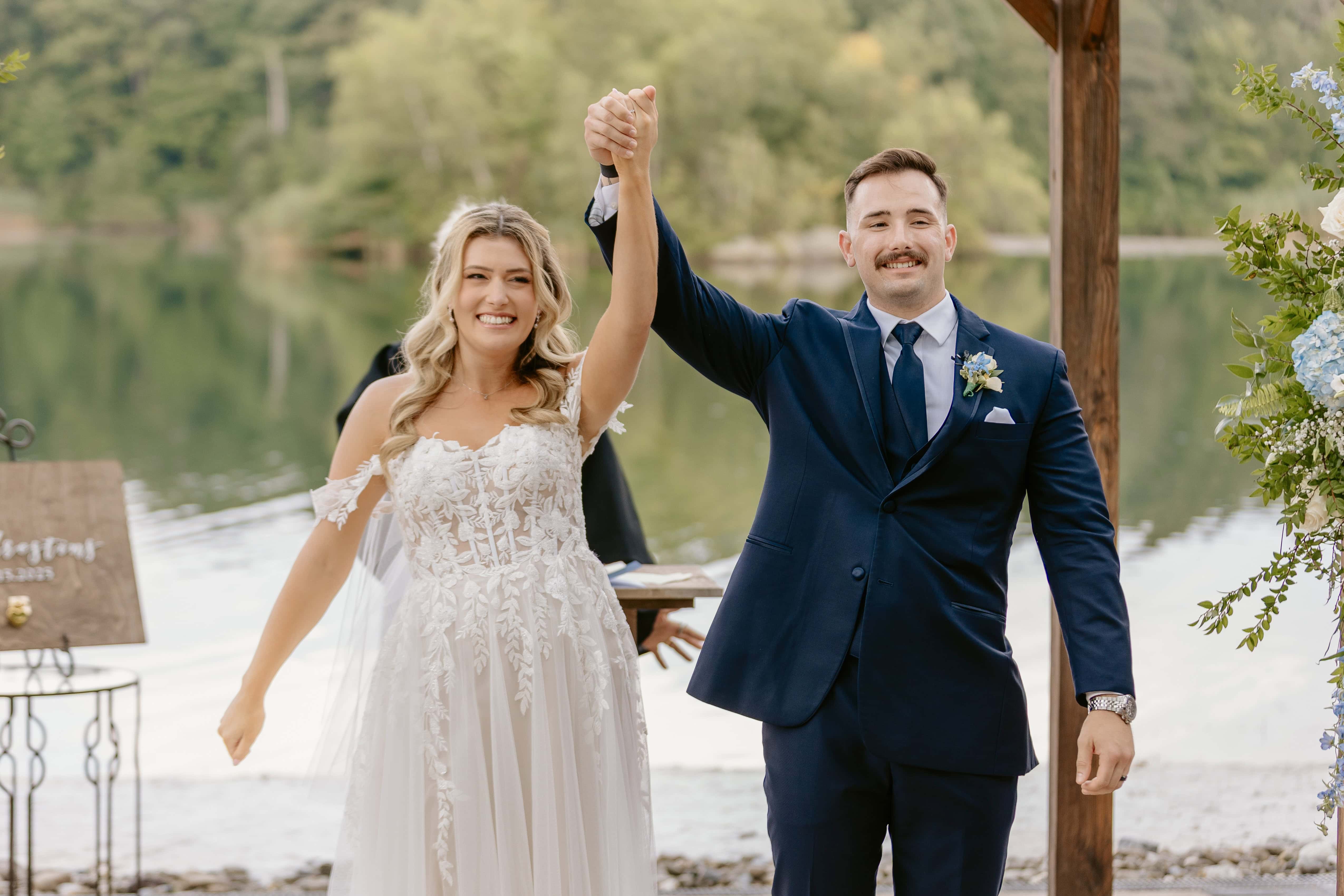 Bride and Groom hold up hands during Ceremony for a New Jersey Wedding Photo at Rock island Lake Club