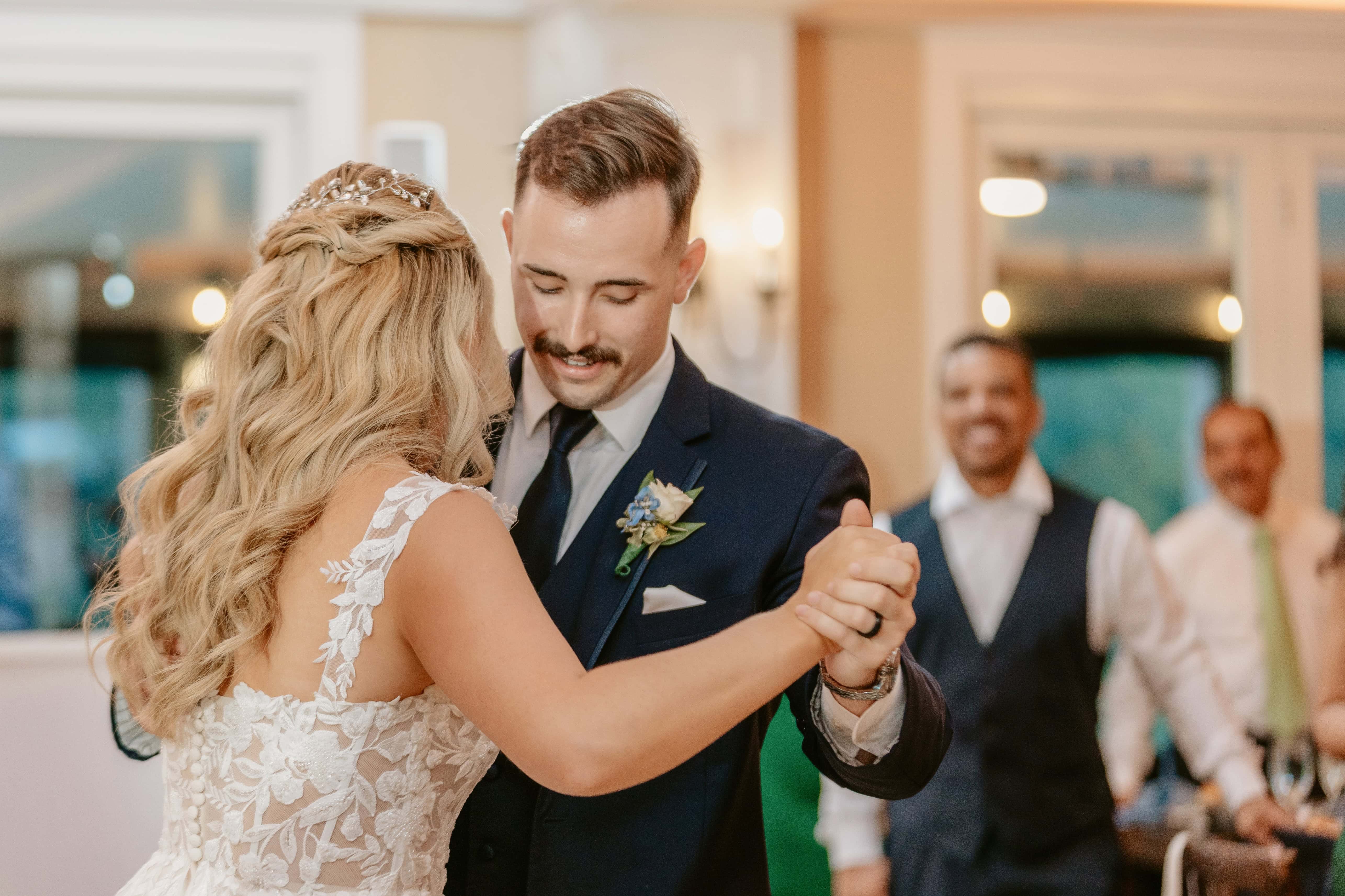 Groom Smiles while dancing with bride during first dance for a New Jersey Wedding Photo at Rock island Lake Club