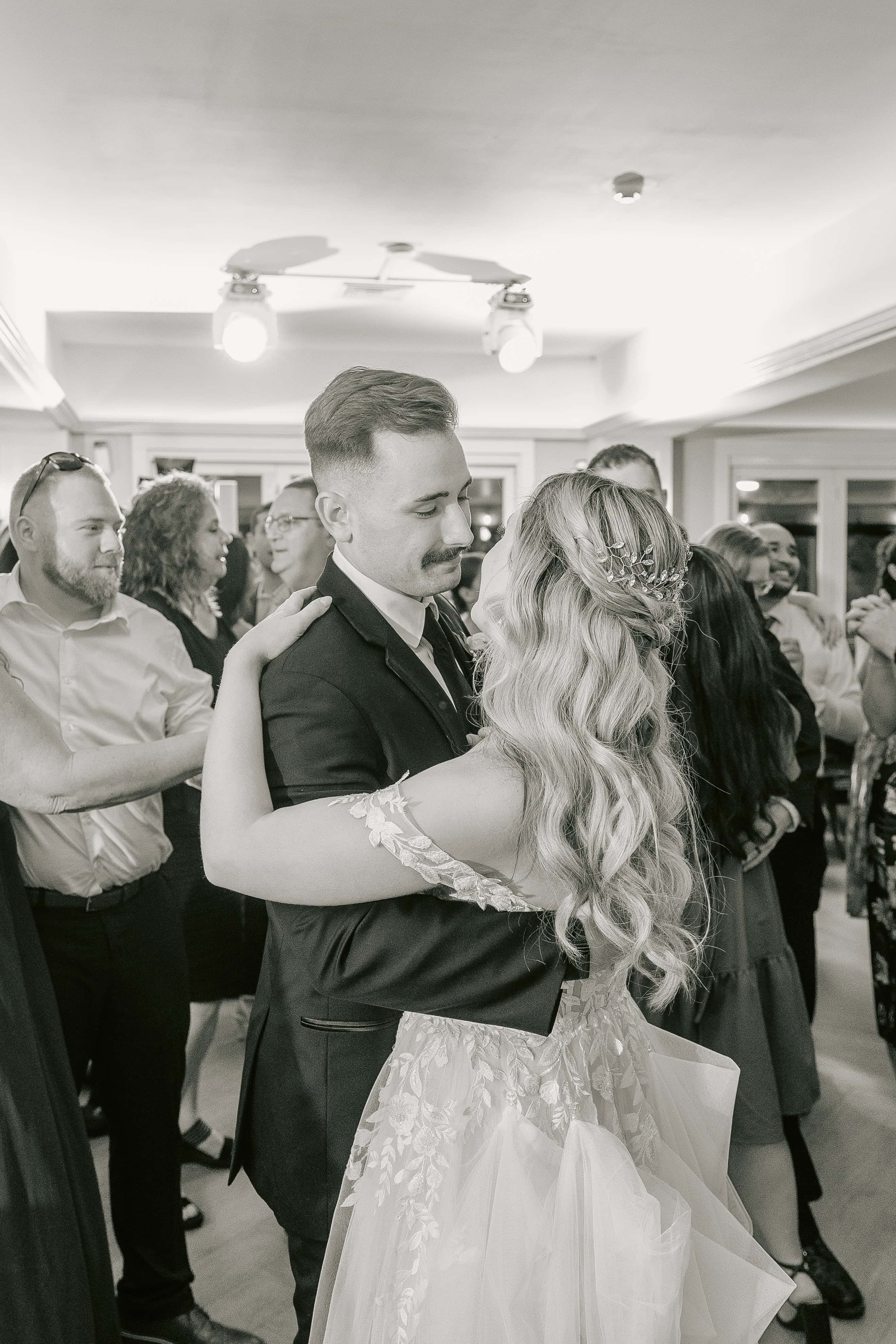 Black and White photo of Bride and Groom Dancing and Smiling for a New Jersey Wedding Photo at Rock island Lake Club