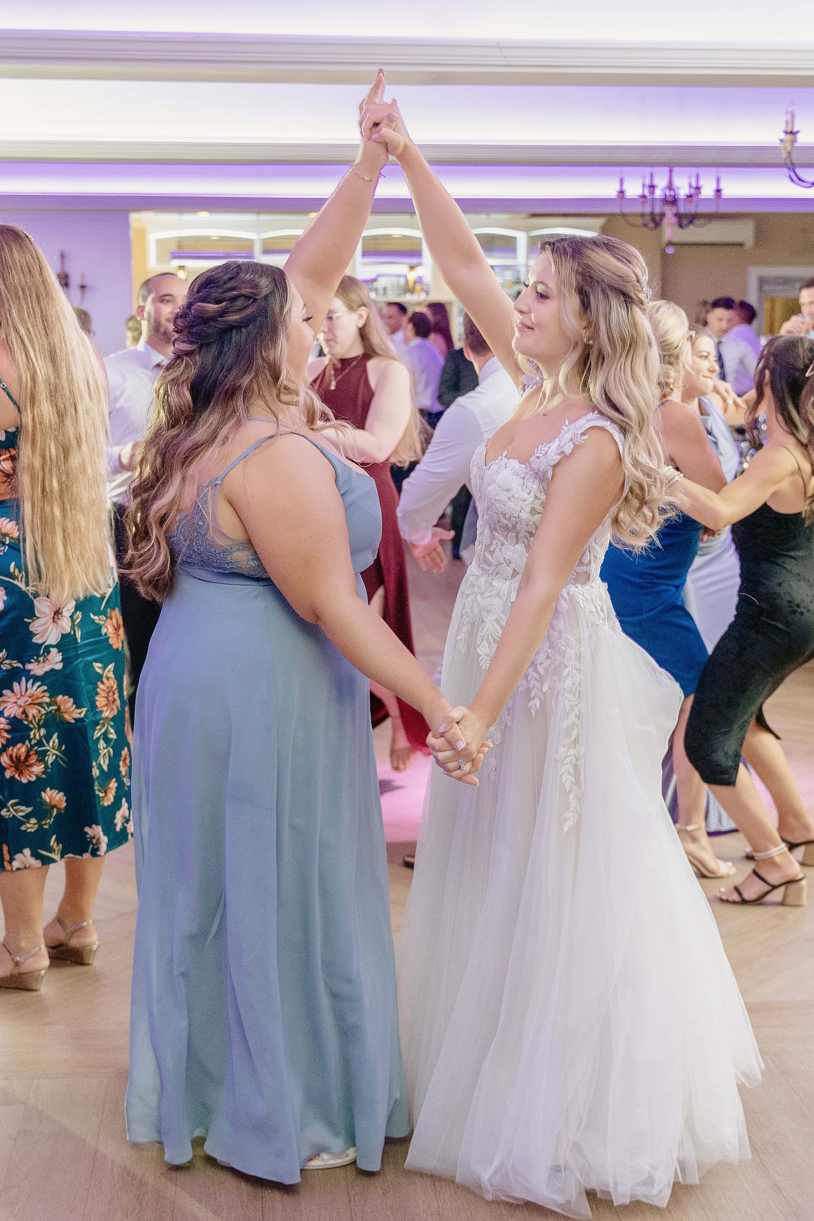 Bride Dances with Bridesmaid for a New Jersey Wedding Photo at Rock island Lake Club