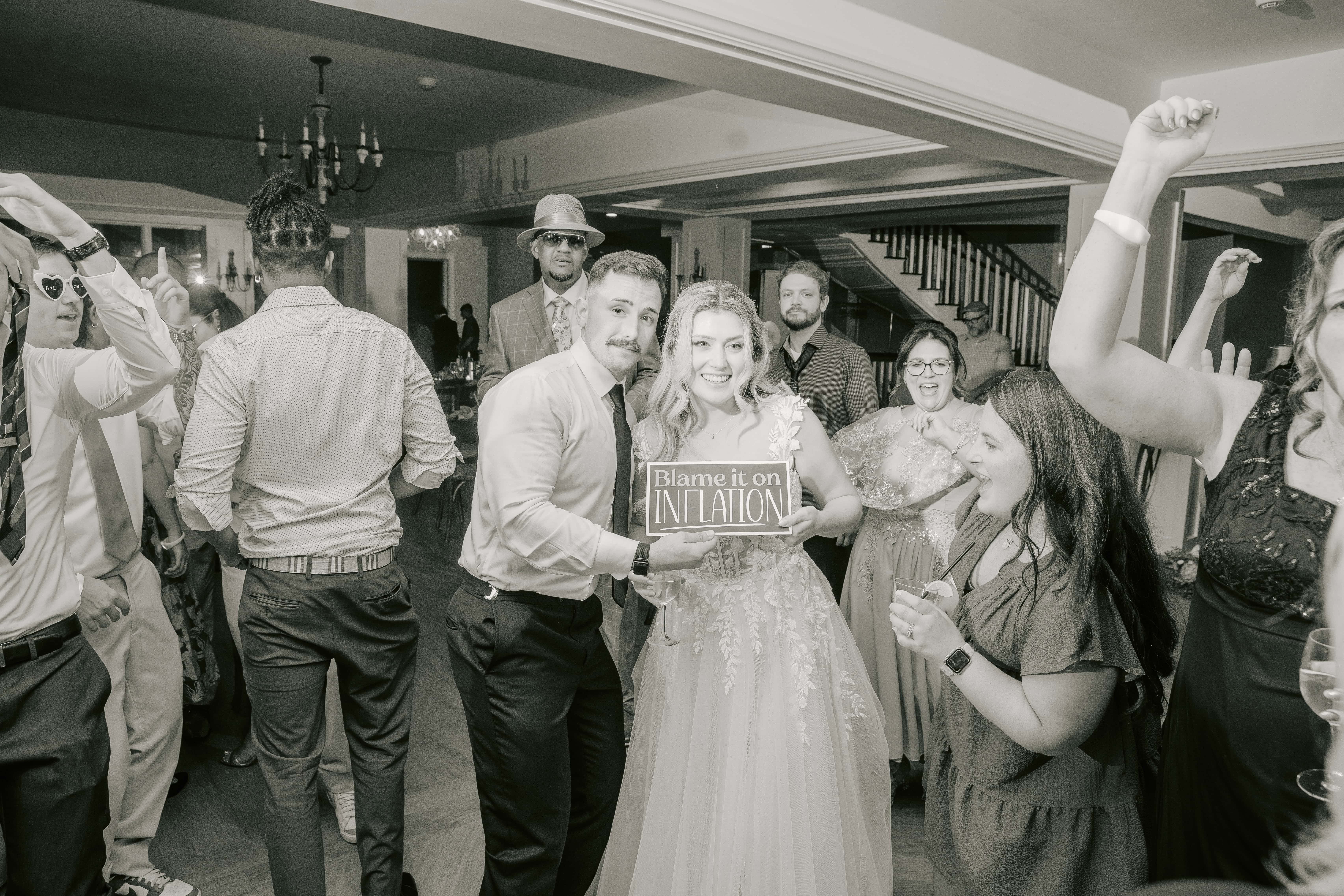 Black and White photo of Bride and Groom Holding Sign for a New Jersey Wedding Photo at Rock island Lake Club
