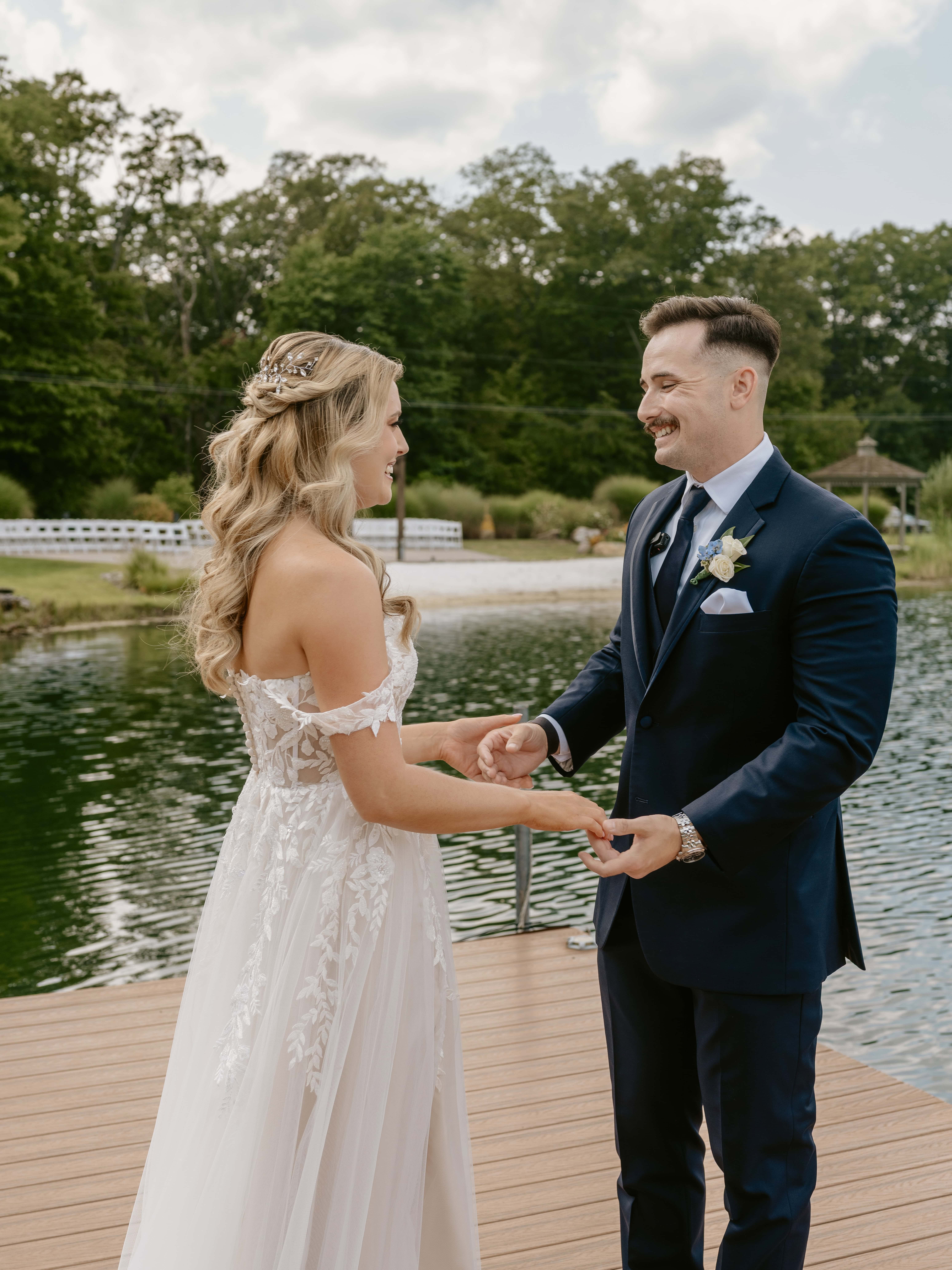 Bride and Groom Hold hands and smile on a pier for a New Jersey Wedding Photo at Rock island Lake Club