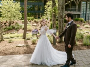 Bride and Groom walk down path and smile for a Hudson Valley Wedding Photo at The Eldred Preserve in the Catskills