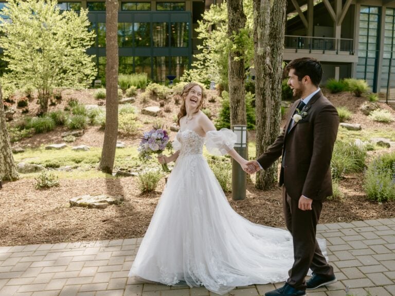 Bride and Groom walk down path and smile for a Hudson Valley Wedding Photo at The Eldred Preserve in the Catskills