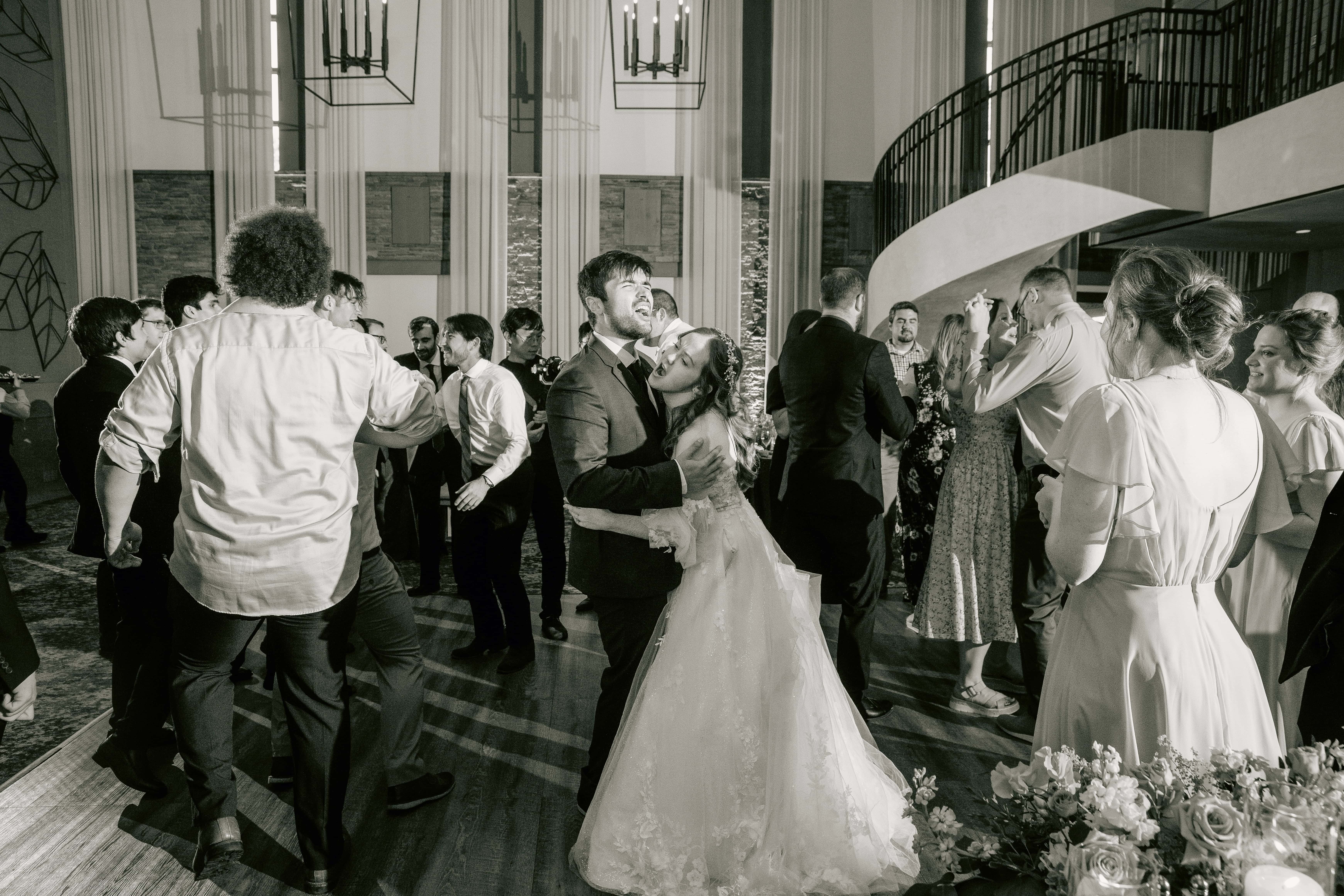 Black and White Bride and Groom Smile and dance for a Hudson Valley Wedding Photo at The Eldred Preserve in the Catskills
