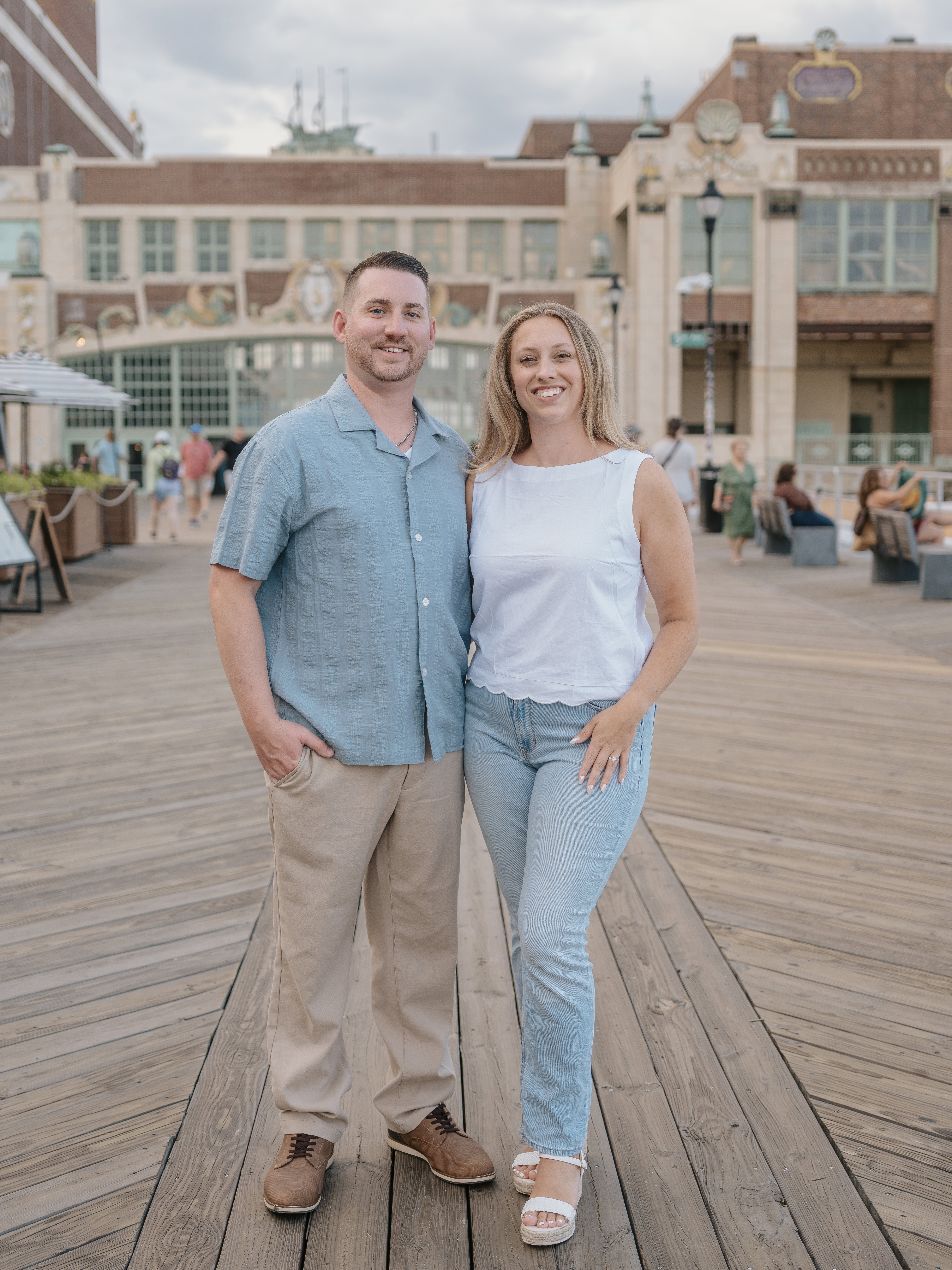 Bride and Groom pose on pier at Sunset for a Asbury Park Engagement Photo